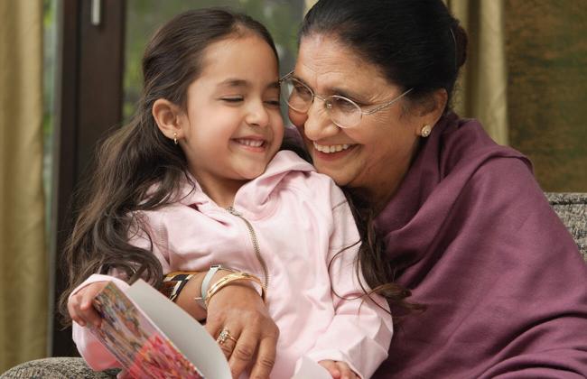 Senior lady smiling with a girl child